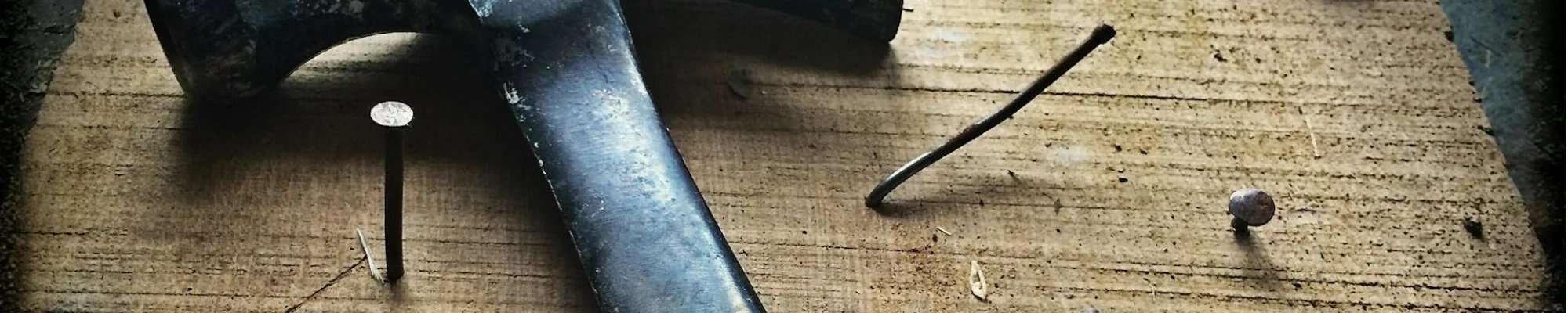 hammer and nails on wooden table